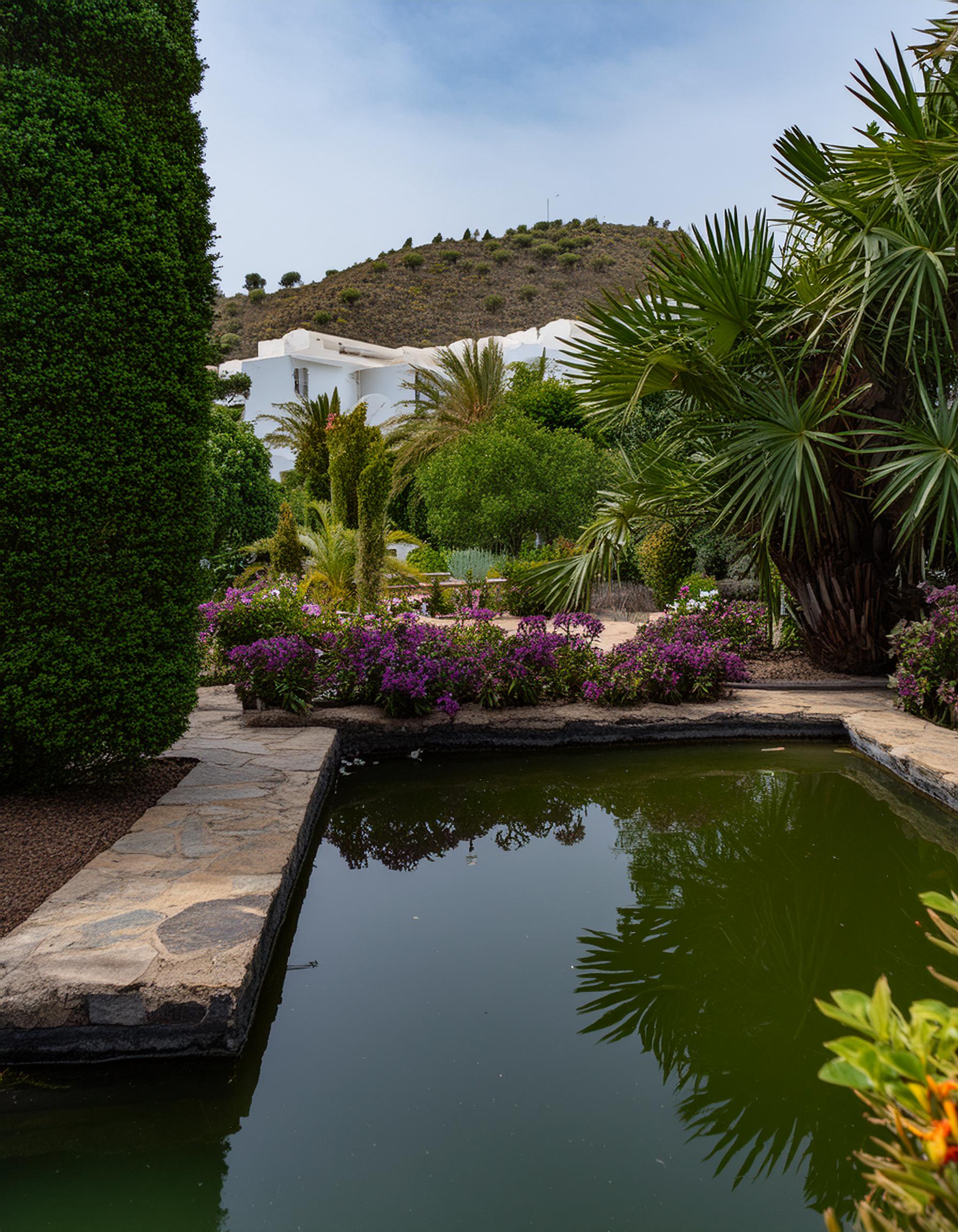 A beautiful Mediterranean villa with a lush, well-maintained garden, showcasing the high-quality gardening services provided by Cobalt Garden.